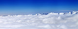 Panorama of mountains under clouds at nice sun day