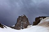 Snowy rocks and storm clouds