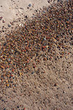 Wet sand and pebbles on Baltic beach. Natural background.