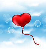 Balloon in the shape of heart in blue sky