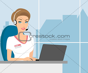 Female call centre operator with headset sitting in the office.