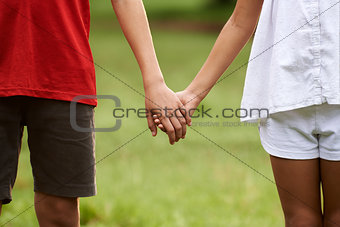 Children in love, boy and girl holding hands