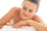 Portrait of relaxed young woman laying on massage table