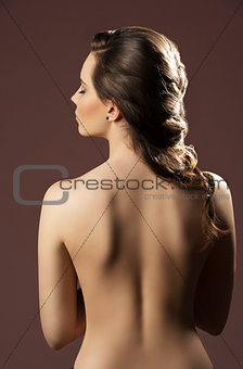 woman with bare back and hairdo 