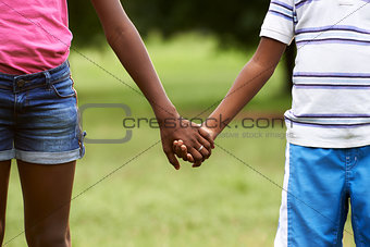 Children in love black boy and girl holding hands