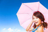 beauty young woman holding a umbrella with blue sky