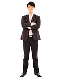 full length of businessman standing and across arms