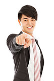 smiling young business man point finger to camera lens