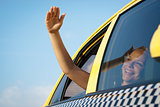 woman in taxi waving hand out of car window