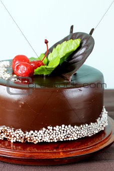 festive beautiful chocolate cake with icing and cherry