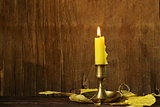 vintage candlestick with candle on the wooden background