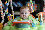 Cute young baby surrounded by toys