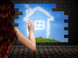 Girl looking at house of clouds in hole in brick wall