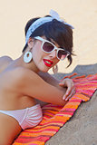 a beautiful young girl in retro look with red lips in a white swim suit