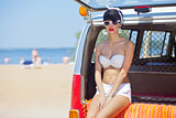 a beautiful young girl in retro look with red lips in a white swim suit
