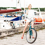 beautiful girl with city bike at sea pier