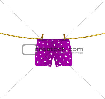 Boxer shorts with white hearts hanging on rope