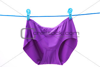 female pants hanging on the blue rope