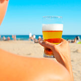 young man having a refreshing beer on the beach