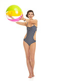 Full length portrait of happy young woman in swimsuit with beach