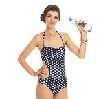Portrait of young woman in swimsuit with bottle of water