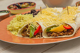Burritos filled with ground beef and peppers