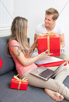 Happy couple exchanging gifts