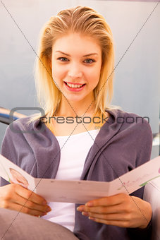 Close-up of a smiling woman holding card
