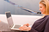 Smiling young woman using laptop