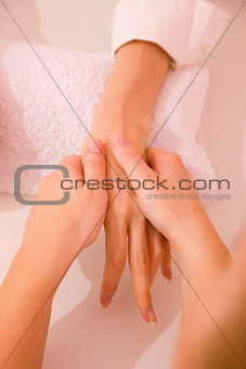 Masseuse massaging hand