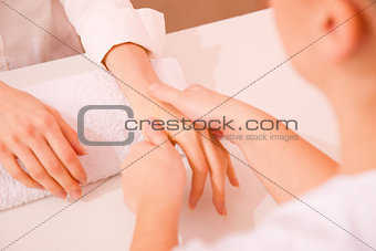 Masseuse massaging hand
