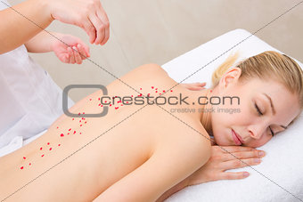 Woman receiving massage with salt crystals spa