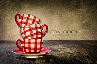 Colorful coffee cups on the table in vintage style
