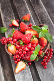 Fresh strawberry and redcurrant in a basket