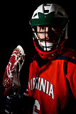 Lacrosse player wearing helmet and holding stick.