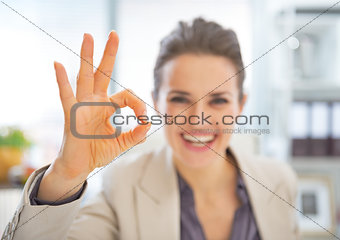 Closeup on happy business woman showing ok gesture
