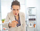 Angry business woman threatening with finger