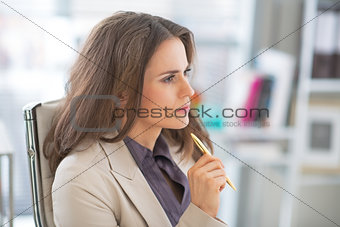 Portrait of thoughtful business woman at work