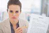 Portrait of business woman pointing on document