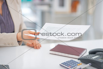 Closeup on business woman giving document