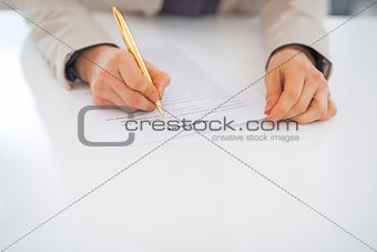 Closeup on business woman working with document