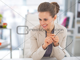 Portrait of smiling business woman with eyeglasses in office