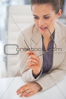 Portrait of thoughtful business woman with eyeglasses in office