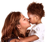 Cheerful mother kissing baby