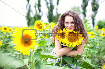 The girl among sunflowers