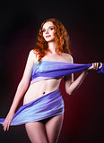 Studio portrait of sexy young ginger woman covered in cloth