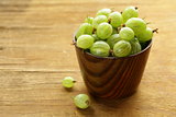 fresh ripe green gooseberries on wooden table