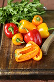 fresh colorful bell peppers on a wooden background
