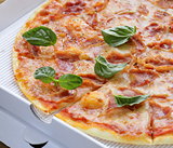 traditional Italian pizza with prosciutto ham and basil