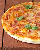 traditional Italian pizza with prosciutto ham and basil